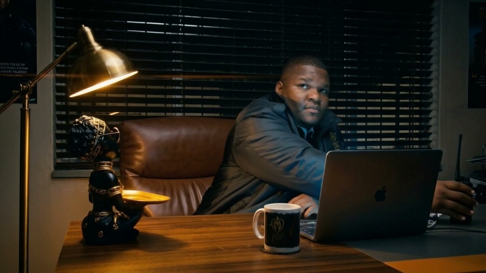 Scene 01 Command - Operations manager at wooden desk answering the radio under warm amber lamp